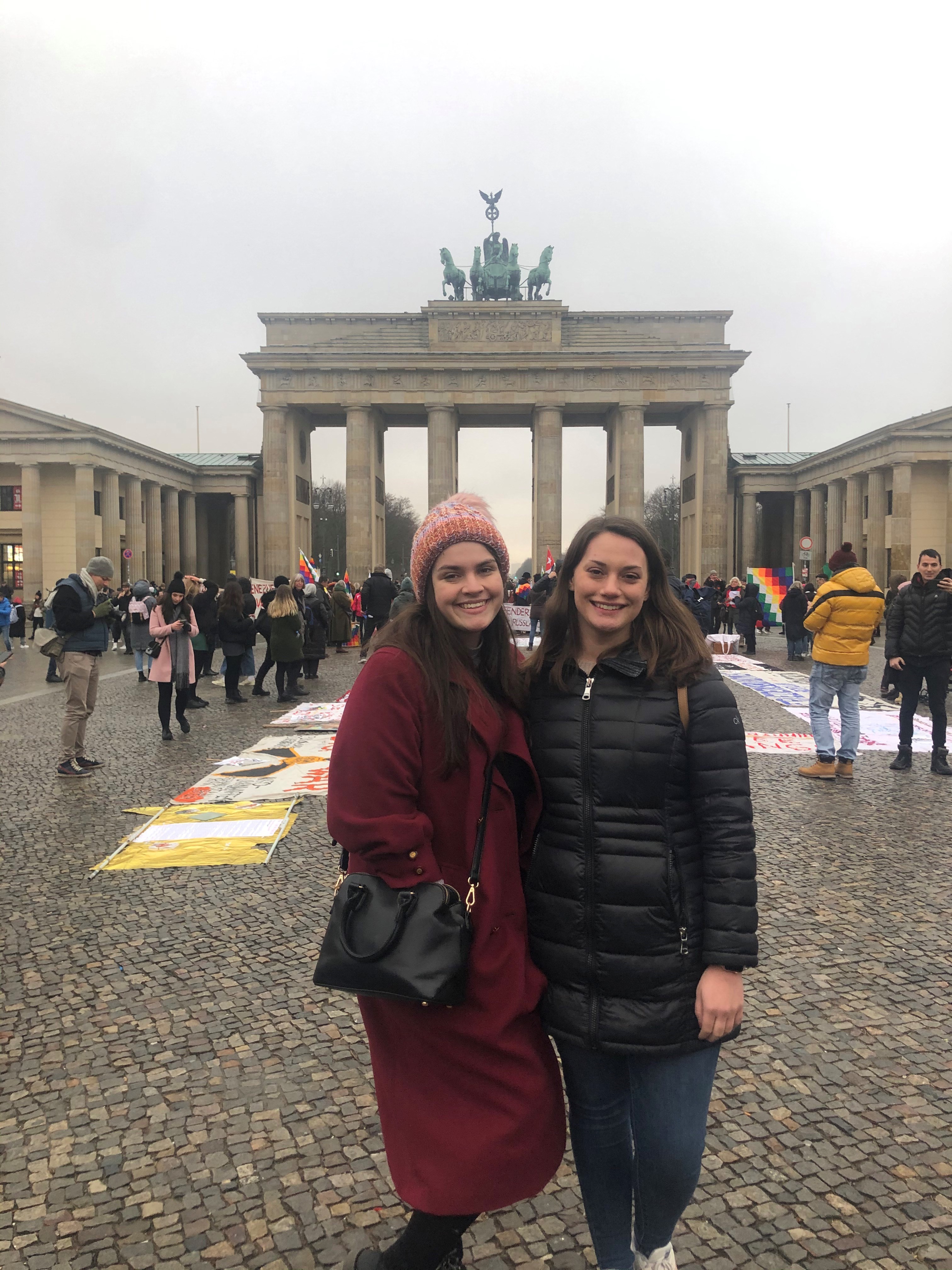 Two students in front of a monument
